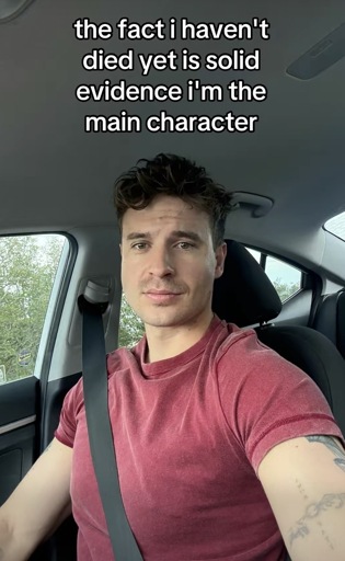 Selfie of a man in a car with the caption “the fact i haven't died yet is solid evidence i'm the main character”